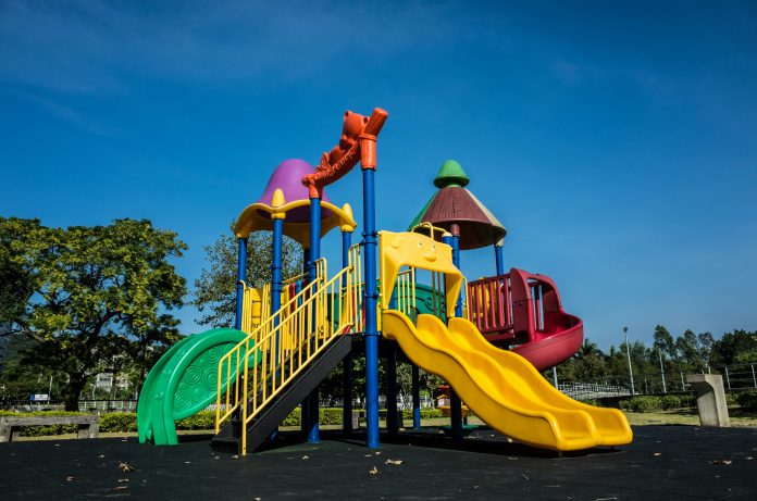 Empty playground with a slide and climbing frame on a sunny day