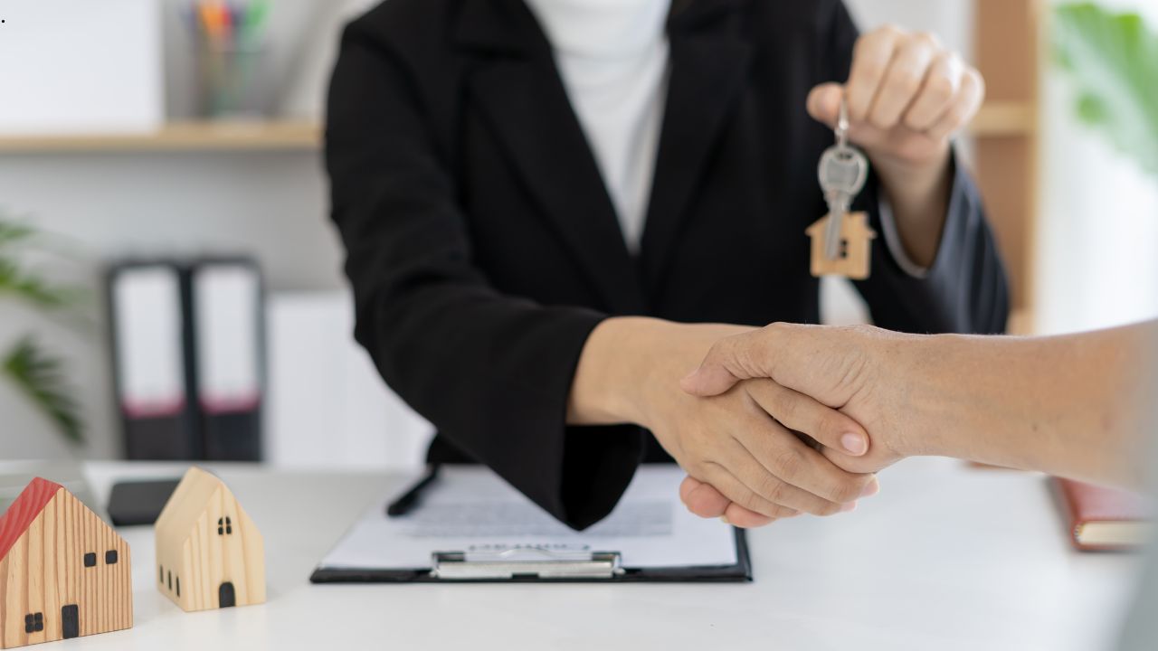 A man selling and taking the key of house